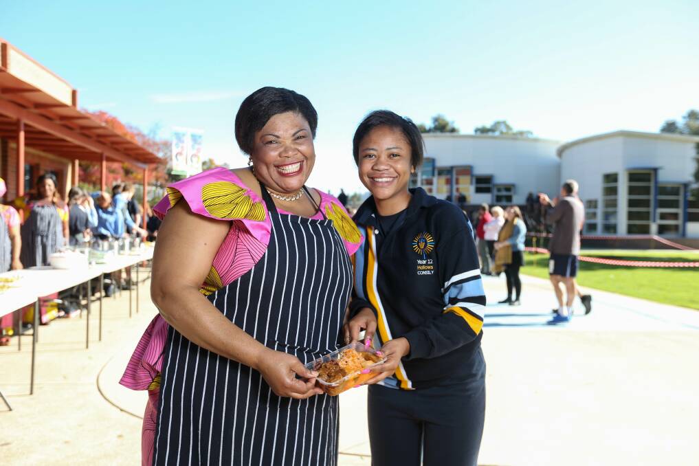 SERVED WITH A SMILE: Catholic College Wodonga year 12 student Concilie Bashimbe and her mother Annie Rwendakulema with Congolese food served to the school. Picture: TARA TREWHELLA