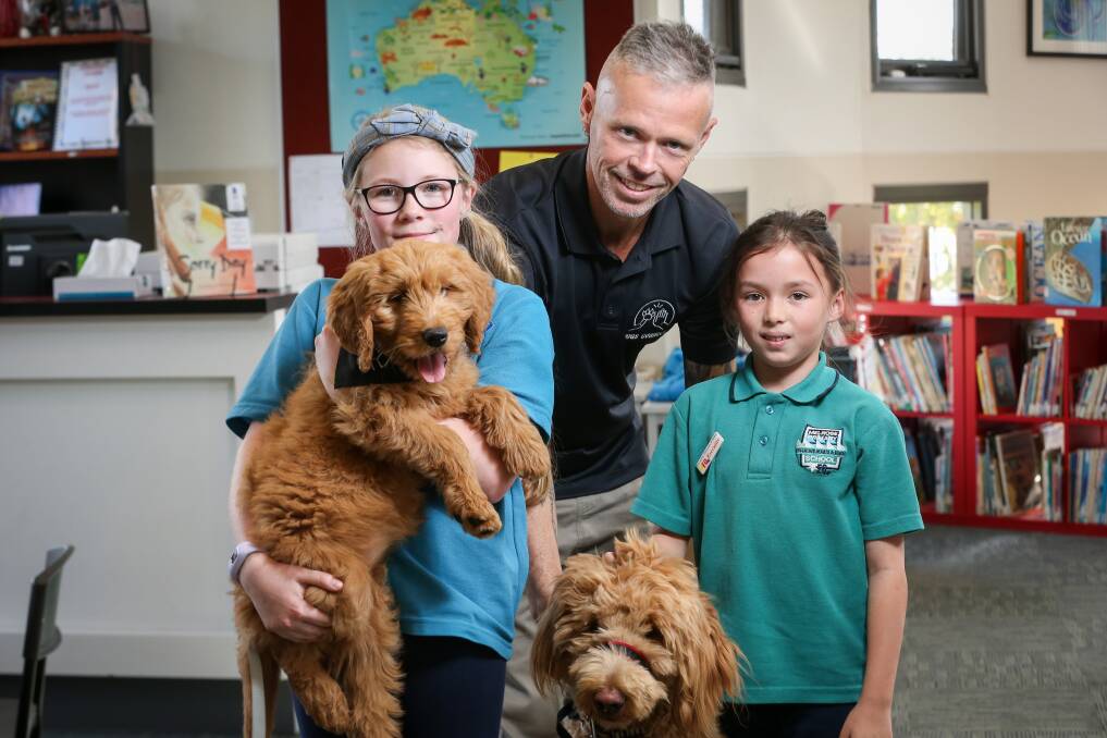 NEW FRIENDS: Olivia Smith, 10, with Meeka, Dogs Connect founder Grant Shannon and Sophie Tatam, 10, with Jack. Picture: JAMES WILTSHIRE