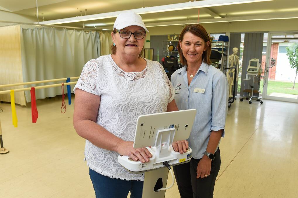 EARLY DETECTION: Patient Helen Moreland uses the new BIS machine at Albury Wodonga Health with lymphoedema practitioner Kate Dahl. Picture: MARK JESSER