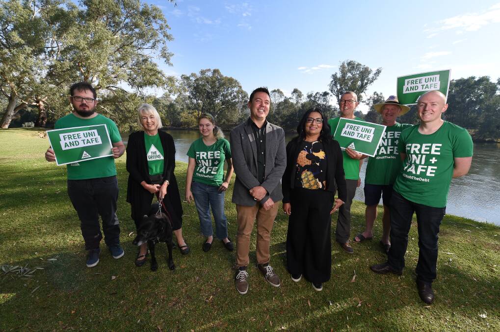 GREEN: Greens candidate for Farrer Dean Moss and NSW Greens Senator Dr
Mehreen Faruqi with Greens supporters at Noreuil Park on Wednesday. Picture: MARK JESSER