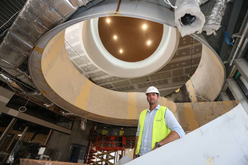 ENTRANCE: Project manager Matt Chisholm on the circular staircase which joins the library to the galleries.
