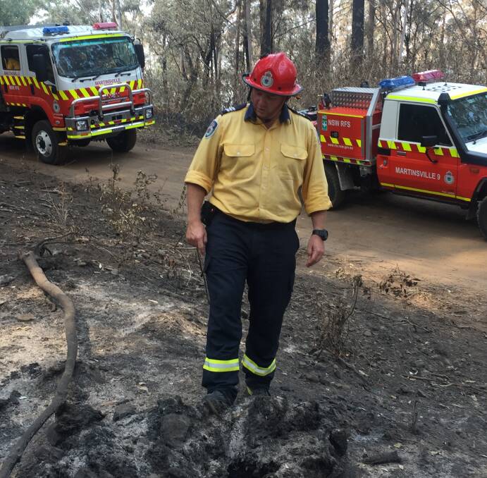 Brigade captain Luke Masters inspects the area near where the October 26 fire began. Picture: Scott Bevan 