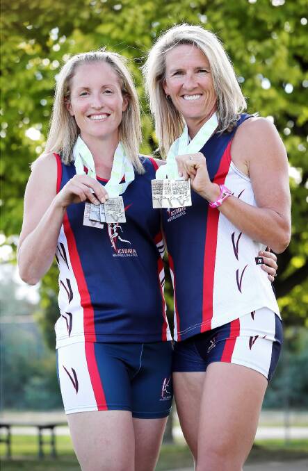 Lisa Ryan and Rachel Little show off their medals. Picture: JOHN RUSSELL