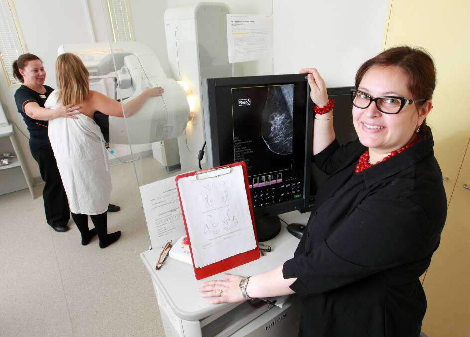 Regional Imaging senior mammographer Sue Gibbins positions a patient in the new 3D machine while women’s imaging specialist Dr Nalini Bhola inspects pictures. Picture: KYLIE ESLER