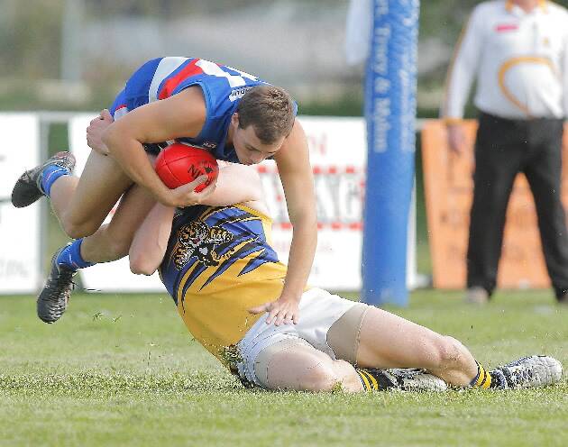 The only place Bulldog Nigel Colman is going in this contest is down after a fierce tackle by Justin Gordon. Pictures: TARA GOONAN
