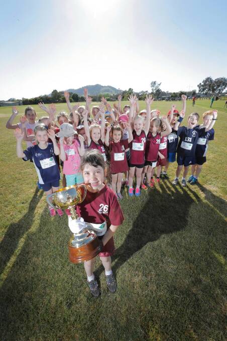 Wodonga and Albury Little Athletics members were delighted to have the opportunity to see and hold the Melbourne Cup on Saturday morning. Ruby Fraser, 6, of Wodonga, with the Cup. Picture: TARA GOONAN