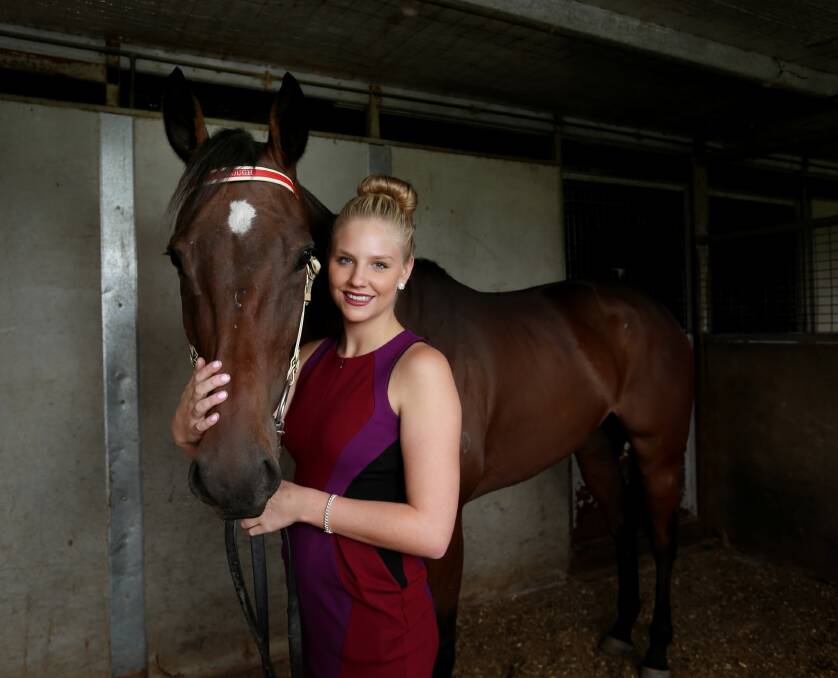 Jess Cavanough looked equally stunning yesterday when she posed with one of her father’s horses. Picture: MATTHEW SMITHWICK