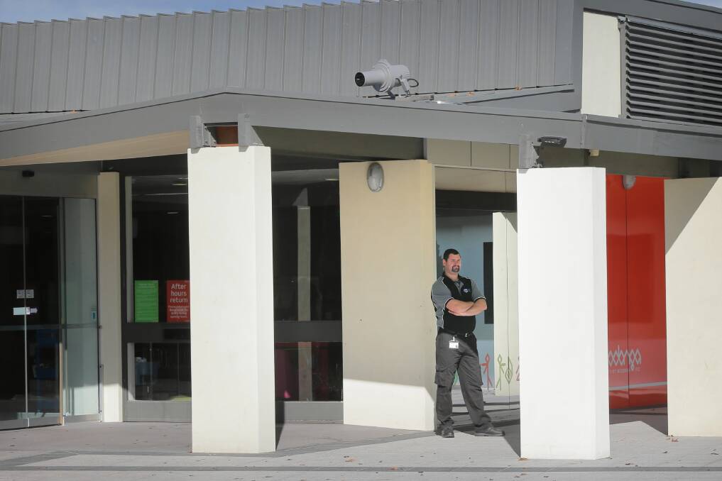 A security guard outside the Wodonga library has been employed to control unruly behaviour.