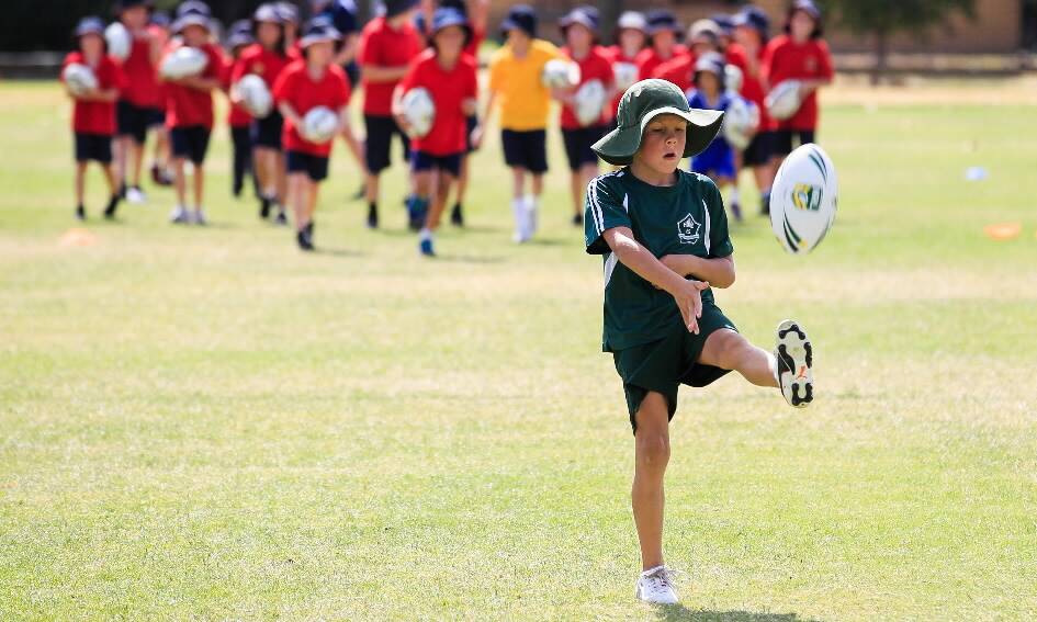 Hume Public School’s Lincoln Schneider, 8, has a kick at yesterday’s clinic.