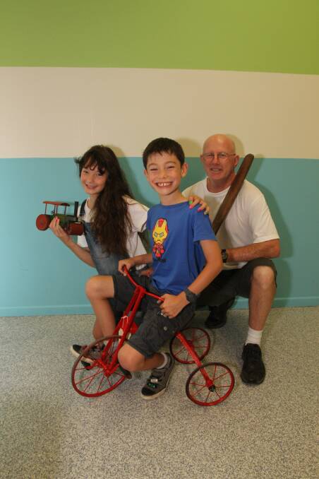 Cleveland grandfather John Aberdeen enjoys some of the historic toys at the hall of fame with his grandchidlren, Sienna Wu, 10, left, and Finlay Wu, 8, who were visiting from Canberra during the summer school holidays. Photo by Chris McCormack