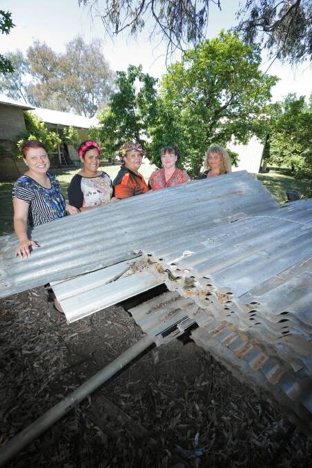 Getting down to tin tacks: Ruth Davys, Tamara Murray, Sharron Edwards, Patricia Cerminara and Lorraine Connelly-Northey are working on the exhibition to mark the gallery reopening. Picture: TARA GOONAN