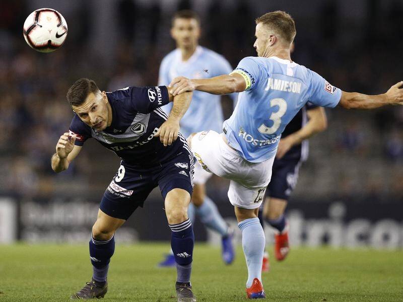 Victory's Kosta Barbarouses (l) and Scott Jamieson of Melbourne City battle for possession.