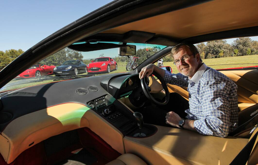Border Christian College principal Phil Murray tests out a 1992 Lamborghini Diablo for size. The car will feature at the school’s Autofest in Thurgoona next Sunday. Picture: DYLAN ROBINSON