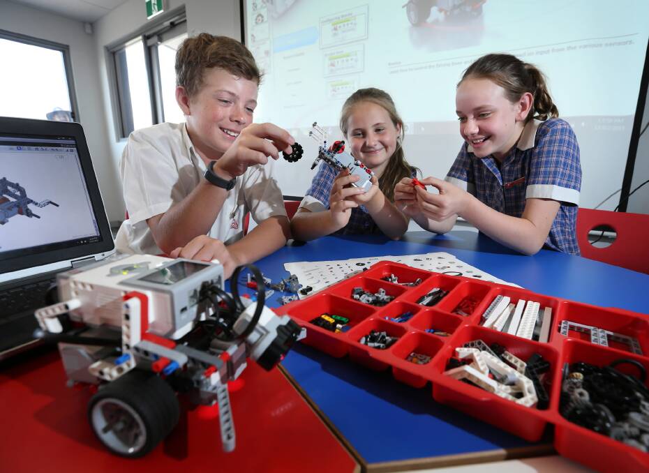Trinity’s Levi Senini, Kyla Anderson and Laura Trebley have shown they are super keen to immerse themselves in the college’s course that involves building robots from scratch. Picture: MATTHEW SMITHWICK