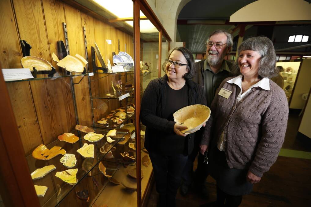 Heritage consultant Mary Casey, a director of Casey & Lowe, helps Geoff and Kerrie Ford of the National Museum of Australian Pottery open the first exhibition of some of Australia’s earliest pottery. Picture: MATTHEW SMITHWICK