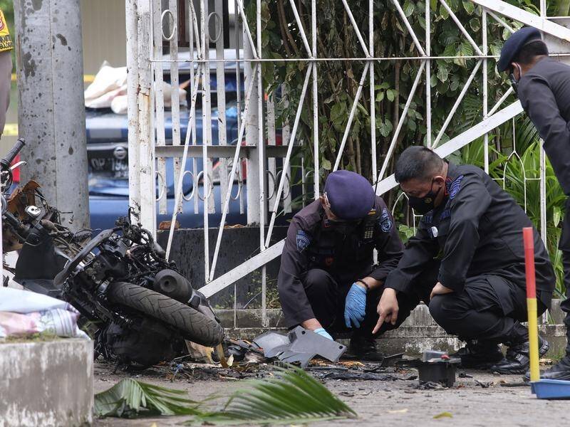 Indonesian police examine evidence in the aftermath of a suicide bombing in the city of Makassar.
