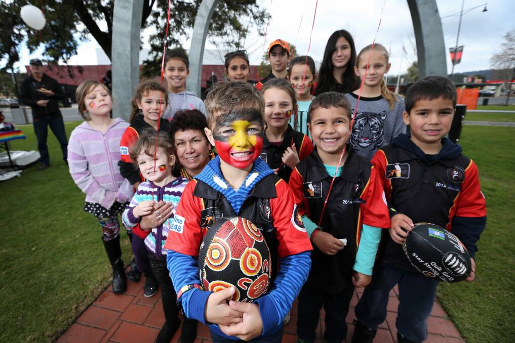 Mase Murray, 6, celebrates the beginning of NAIDOC Week with his grandmother Valda Murray and other youngsters at Woodland Grove in Wodonga yesterday. Picture: MATTHEW SMITHWICK