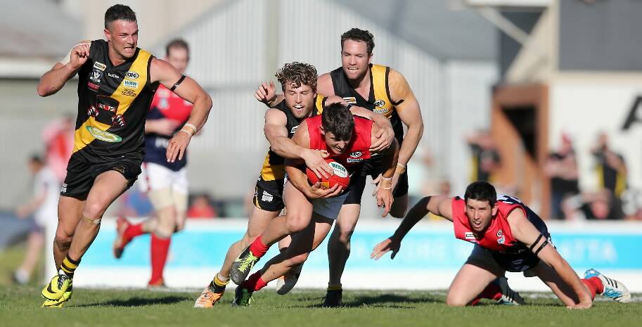 Tiger Guss Gray traps Demon Nathan Hooper with the ball.