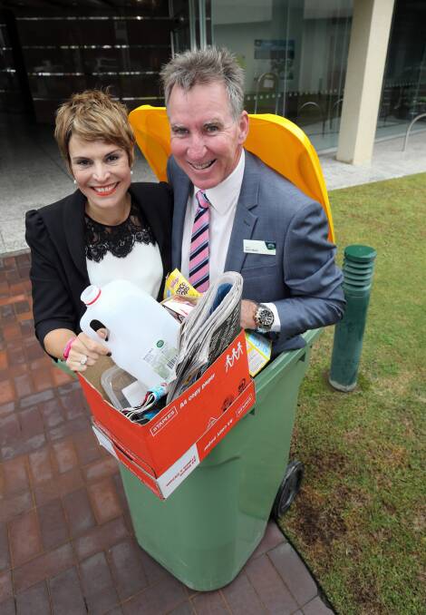 Wodonga councillor Anna Speedie and Albury mayor Kevin Mack show the size of the newest recycling bins, now available at both councils. Picture: PETER MERKESTEYN