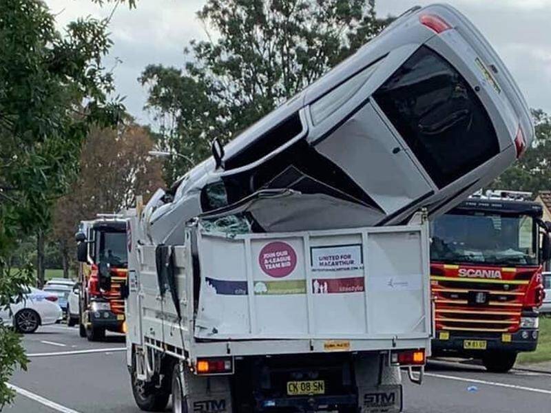 A car has landed in the back of a Sydney council truck after it became airborne in Macquarie Fields.