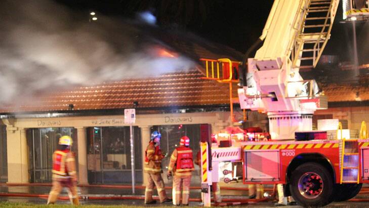 Fire fighters battle the blaze at Donovans restaurant. Photo: Fergus Wells