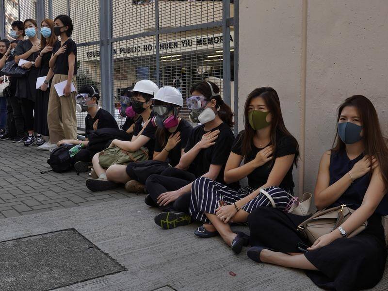 Students at a Hong Kong college condemn the police shooting of a teenager during protests.