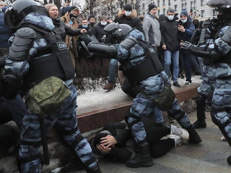 Russian police detain a protester during the protests in Moscow.
