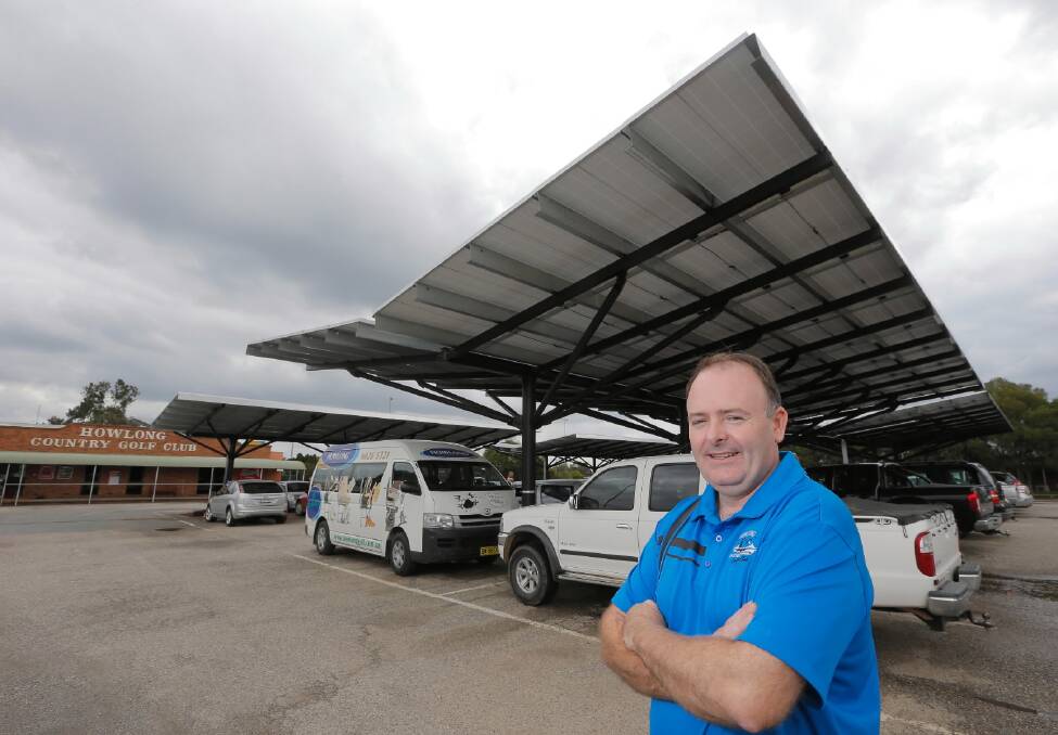 Howlong Golf Resort manager Chris Rebecchi shows off the solar panels that double as an undercover area for car parking. Picture: kylie esler