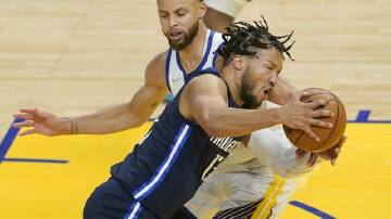Dallas guard Jalen Brunson is defended by Golden State rival Stephen Curry in the Warriors' win.