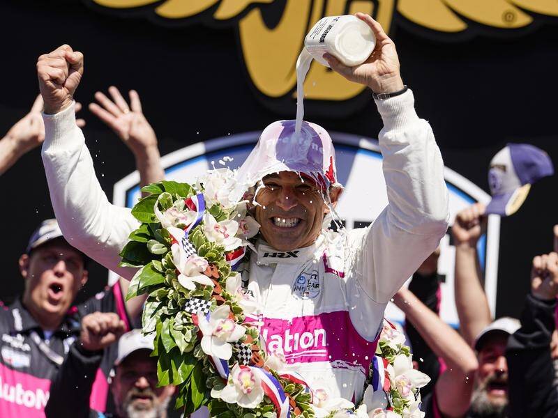 Helio Castroneves celebrates after winning his fourth Indianapolis 500.