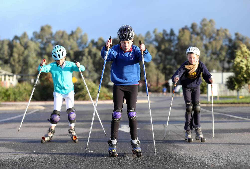 Abigail Wilkinson, 9, Jorja Cullen, 11, and Nicola Baines, 11, on the roller-skis at training in Wodonga. Picture: JOHN RUSSELL