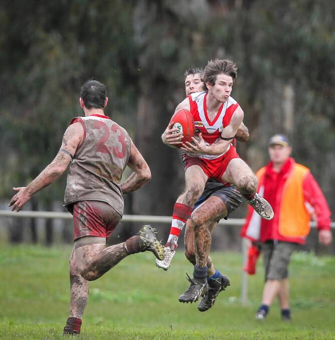 Chiltern’s Tristan Radley shows good wet-weather skills with a strong chest mark against Thurgoona.