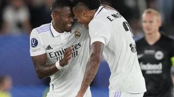 Real Madrid's David Alaba, left, celebrates with Eder Militao after scoring his side's opening goal. (AP PHOTO)