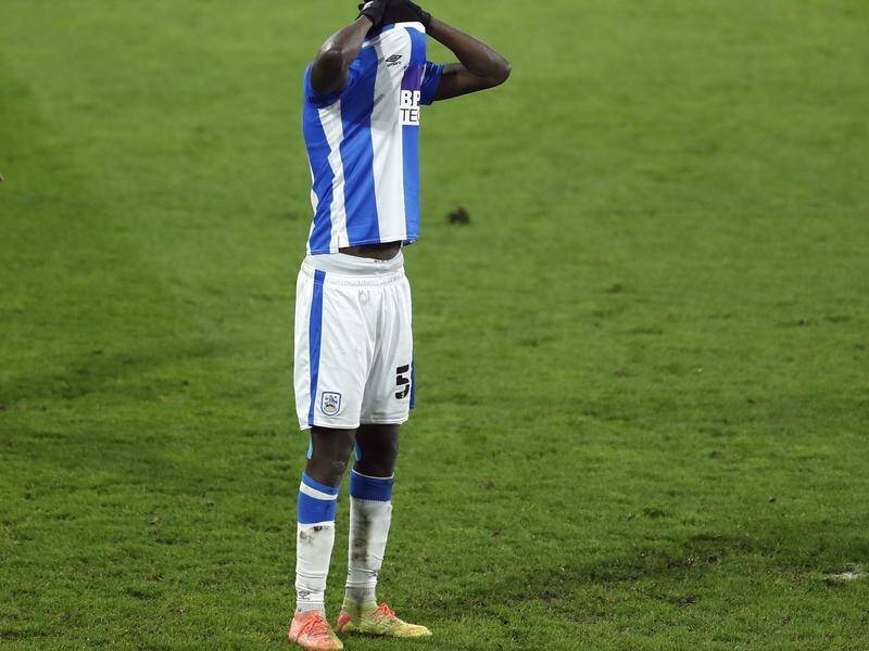 Huddersfield's Yaya Sanogo reacts after missing a penalty against Cardiff City in the Championship.