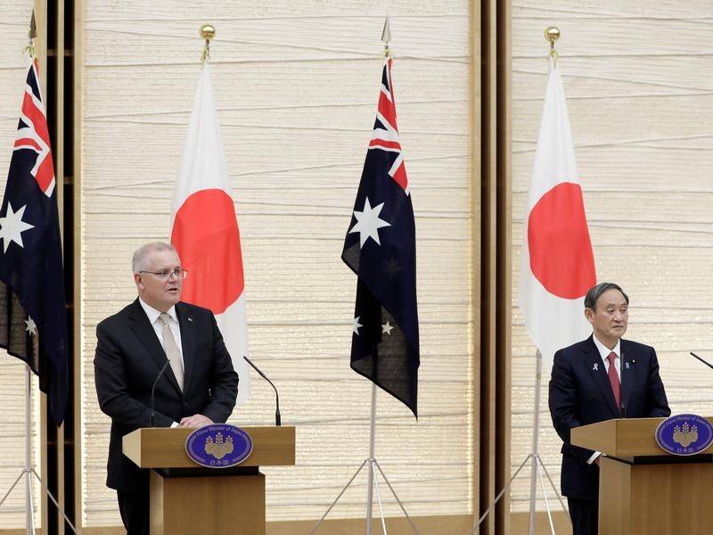 Scott Morrison and Yoshihide Suga have given the green light to an in-principle agreement on defence
