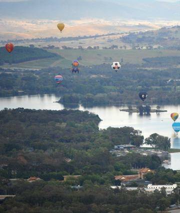  Balloons drift over Lake Burley Griffin. Photo: Graham Tidy