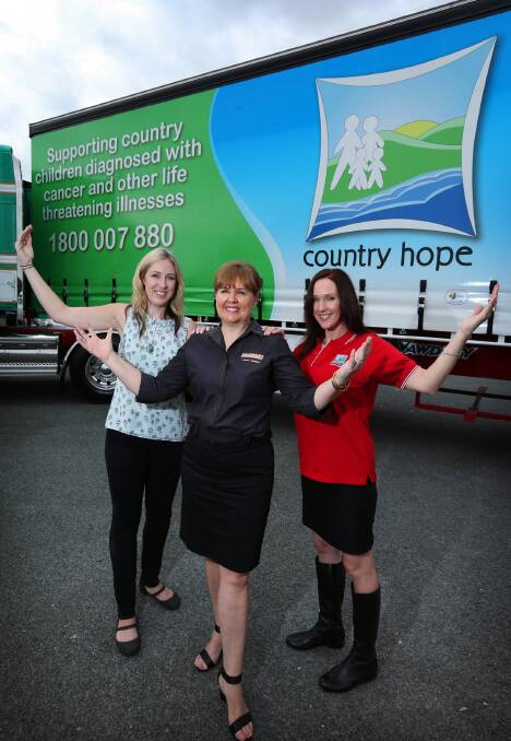 Rice Graphics Images regional sales manager Rebecca Clinton, Dawson’s Haulage director Tracie Dawson and Country Hope manager Nikki Grae in front of the newly branded truck yesterday that promotes Country Hope, which supports young cancer patients and their families. Picture: Matthew Smithwick