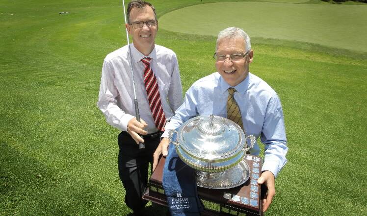 Rotary Club of Albury West president Wayne Moriarty and hospital chief Doug McRae with the trophy up for grabs. Picture: DAVID THORPE