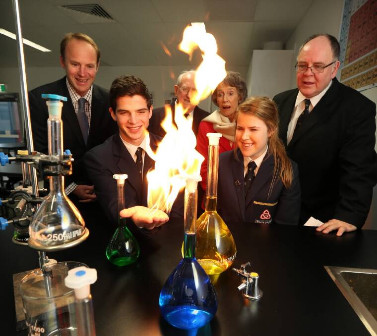 Founders Adrian Farrer, representing his father Bishop David Farrer, Professor David Mitchell, Patricia Gould and Keith Currie watch college captains Christiaan Slabbert, 18 and Laura Thomas, 17 (centre front) perform a science experiment in one of the centre’s new labs. Picture: MATTHEW SMITHWICK