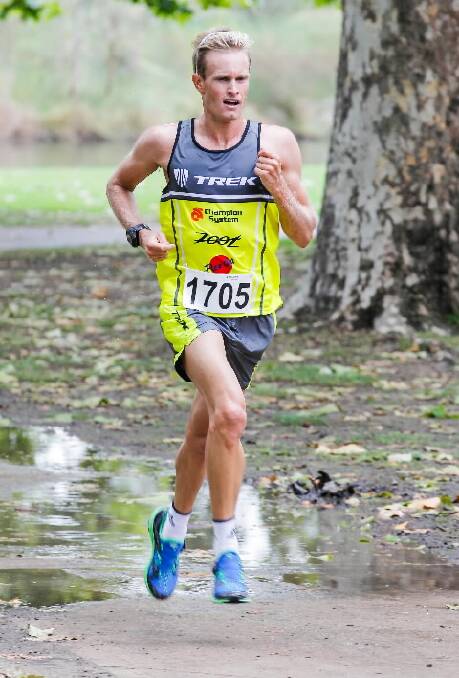 Jesse Featonby powers through the puddles on his way to a dominant win in yesterday’s Cumberoona run.