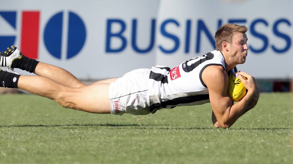 The Magpies’ Ben Reid had to go flat out for this mark.
