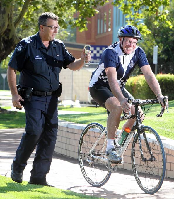 l Acting Sen-Sgt Paul Brady spurs on Peter Renshaw as he trains for his fund-raising bike ride to Melbourne to benefit injured police. Picture: KYLIE ESLER