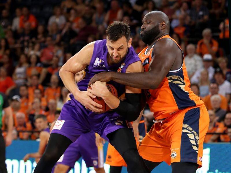 Andrew Bogut and Nate Jawai contest possession as Sydney beat Cairns in the NBL.