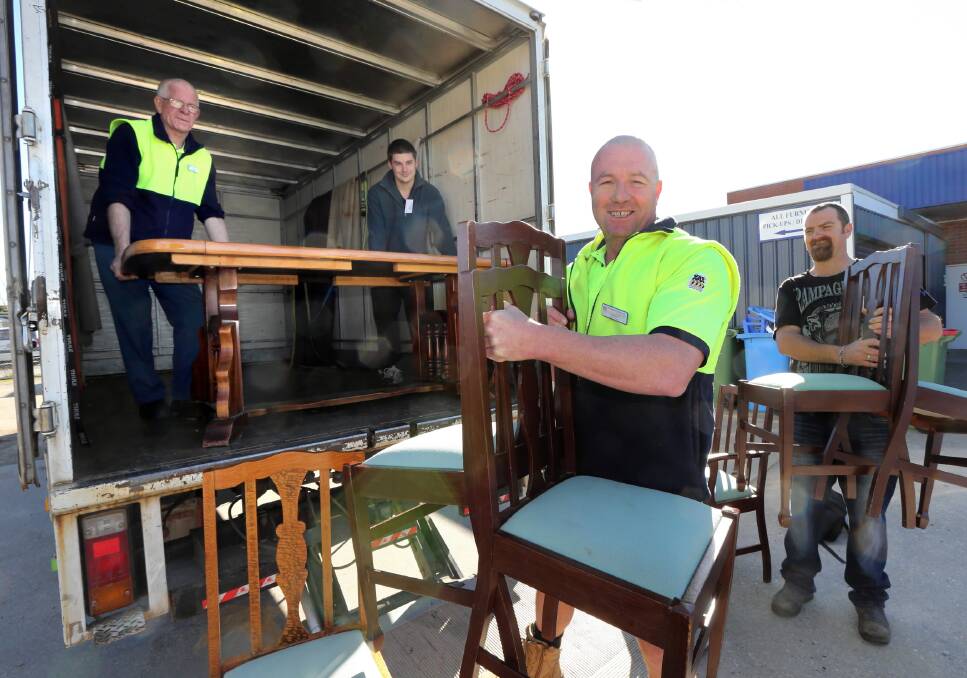St Vincent de Paul employee Peter Newlyn and volunteer Ben Tisdell work with Tony Close and volunteer Craig Evans to deliver furniture to another family in need. Picture: PETER MERKESTEYN