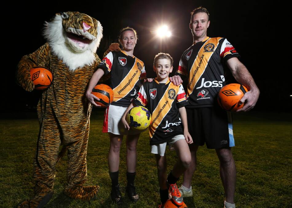 Boomers players Torey Saisanid, Lachie Claxton, 12, and Dustin Patten meet the Albury Tigers’ mascot ahead of the club swapping its usual strips with that of the Albury Football Club to raise money for the James McQuillan Future Fund at Glen Park on Sunday. Picture: MATTHEW SMITHWICK