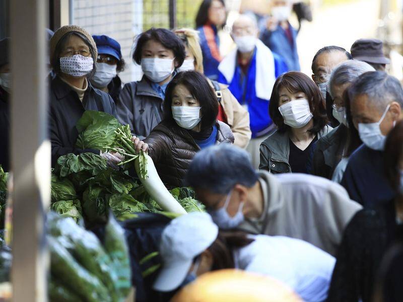 Shoppers seek food at a market in Tokyo as the government sets up a coronavirus task force.