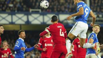 Dominic Calvert-Lewin rises highest to head home Everton's second goal in the derby win v Liverpool. (AP PHOTO)