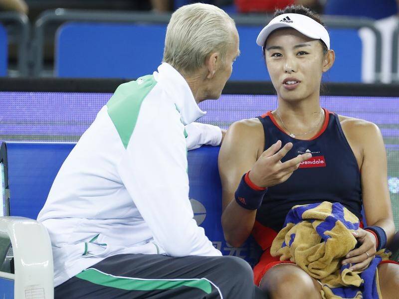 Coach Peter McNamara chats with China's Qiang Wang in September last year.