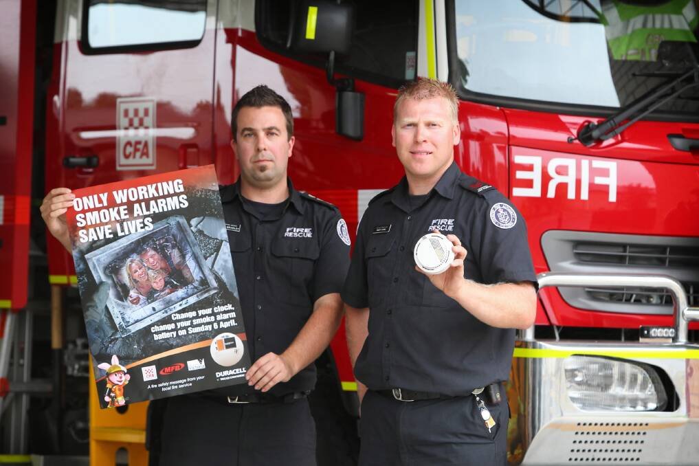 Wodonga senior station officer Lyndon Bradley and leading firefighter Brett Myers remind residents to change smoke alarm batteries when they change their clocks at the end of daylight saving tomorrow. Picture: MATTHEW SMITHWICK