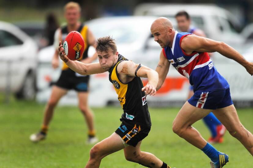 Tigers Jack Price leaves the ball behind as Thurgoona’s Daniel Kannenberg bears down on him.